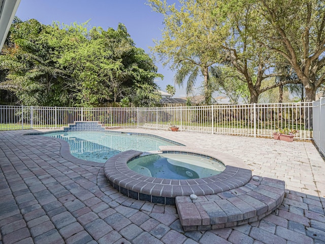 view of pool featuring a pool with connected hot tub, a fenced backyard, and a patio area