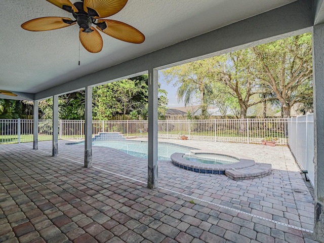 view of pool with a patio, an in ground hot tub, a fenced backyard, and a ceiling fan