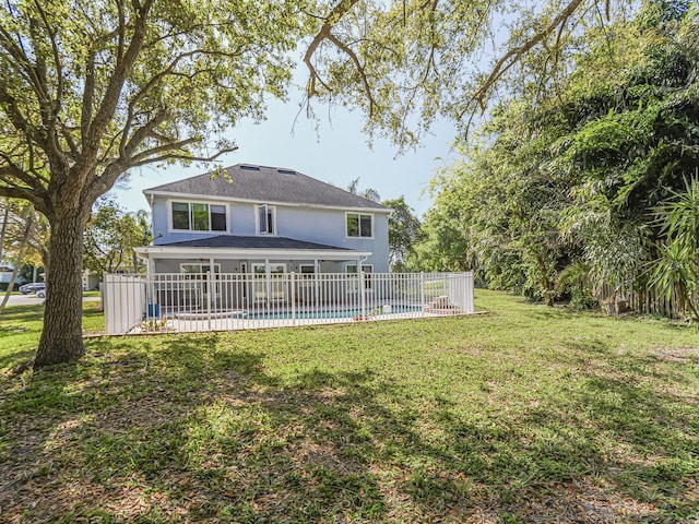 view of yard with a fenced in pool and fence