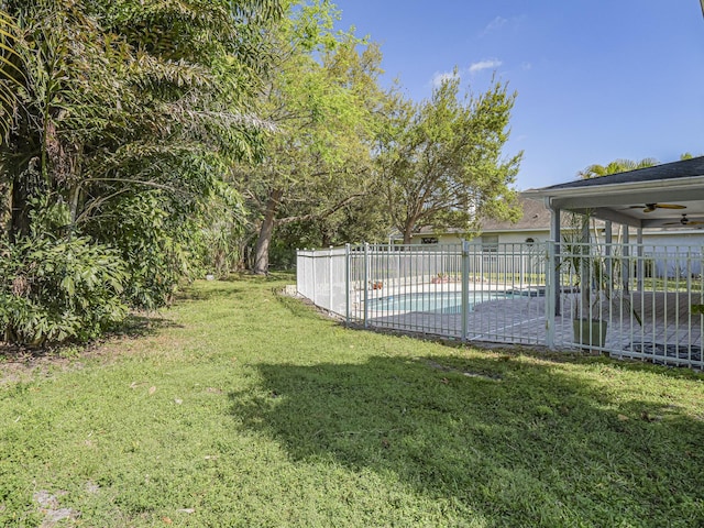 view of yard with a fenced in pool, a patio area, ceiling fan, and fence