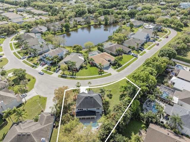 drone / aerial view featuring a residential view and a water view