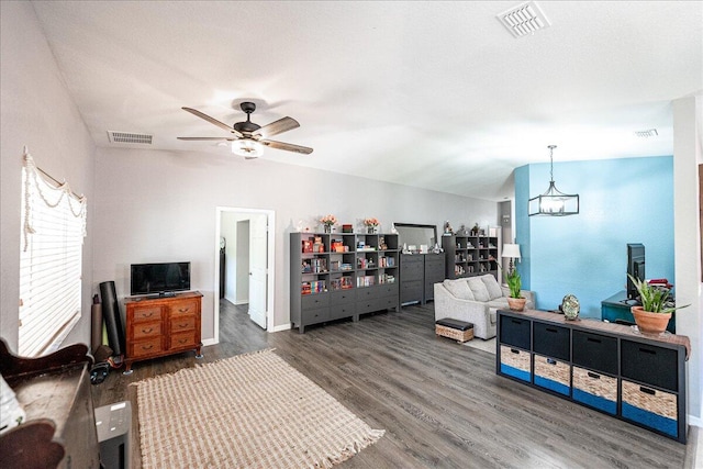 living area featuring visible vents, ceiling fan, and wood finished floors