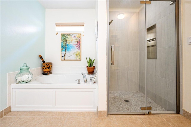 full bathroom featuring a garden tub, a stall shower, and tile patterned flooring