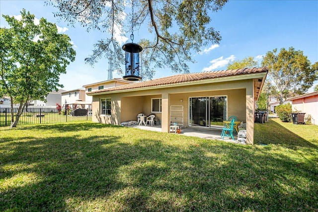 back of property with a patio, fence, a yard, stucco siding, and a tile roof