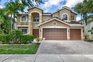 mediterranean / spanish-style house with stucco siding and driveway