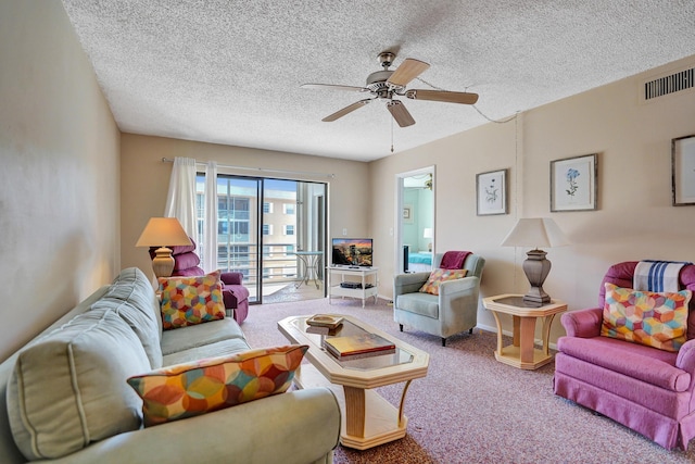 carpeted living room with baseboards, visible vents, a textured ceiling, and ceiling fan