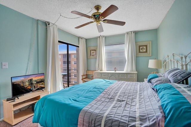 carpeted bedroom with access to outside, a ceiling fan, and a textured ceiling