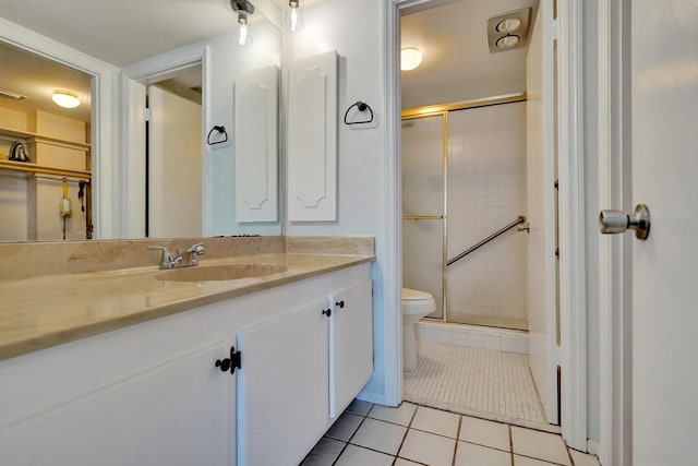 full bathroom with tile patterned flooring, toilet, vanity, and a stall shower