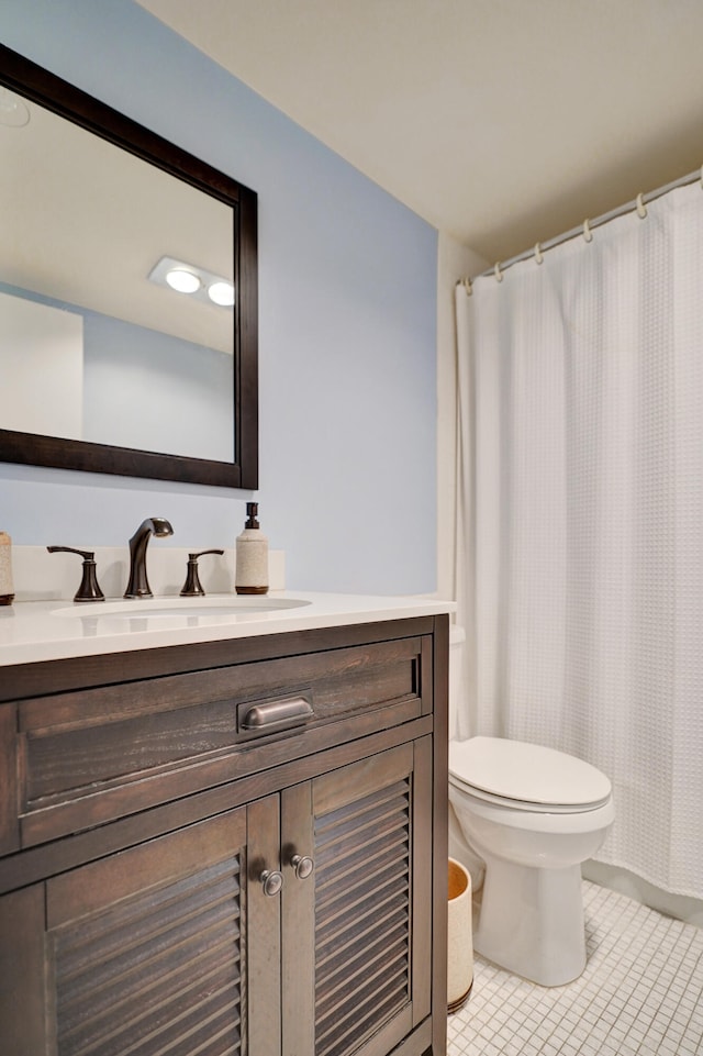 full bath featuring a shower with shower curtain, toilet, vanity, and tile patterned flooring