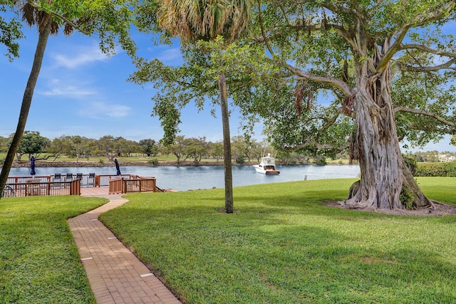 view of yard featuring a water view and a boat dock