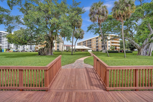 wooden deck featuring a lawn