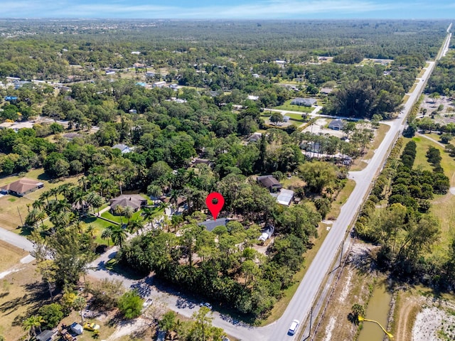 view of property location with a heavily wooded area