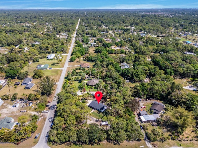 birds eye view of property with a wooded view