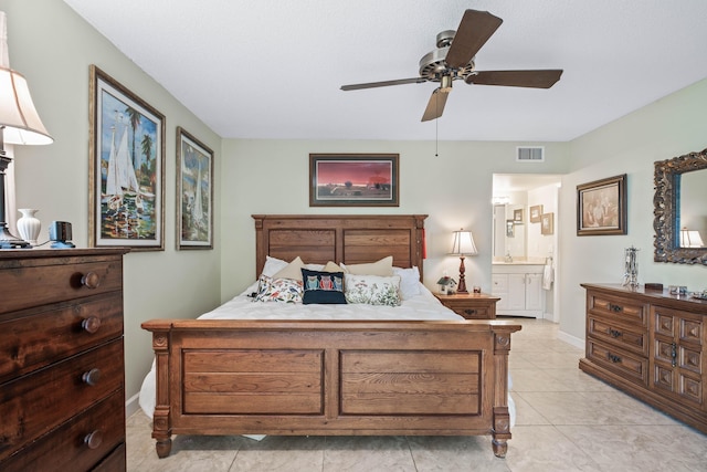 bedroom featuring visible vents, ceiling fan, ensuite bathroom, and baseboards