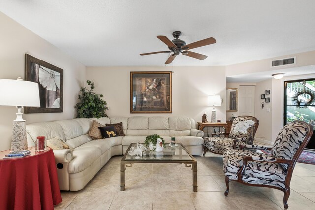 tiled living area with visible vents and ceiling fan