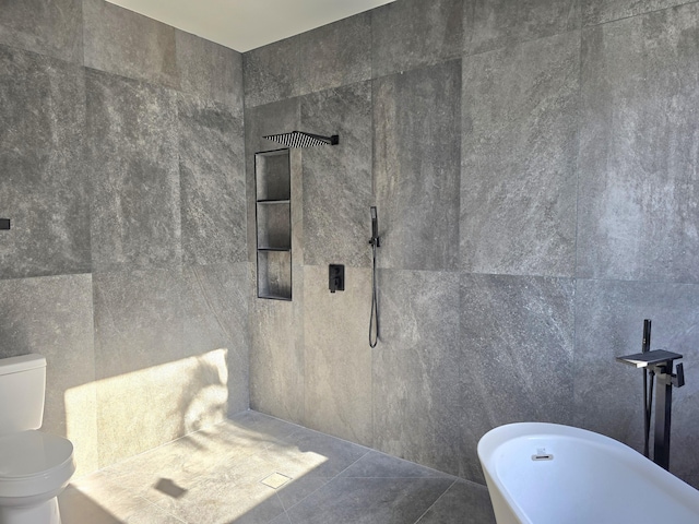 bathroom featuring toilet, tile walls, a soaking tub, and a tile shower