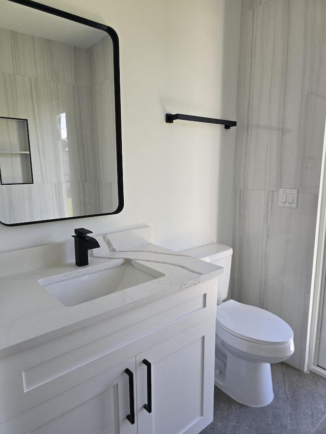 bathroom featuring toilet and vanity