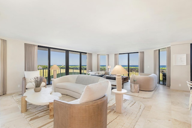 living area featuring floor to ceiling windows, a healthy amount of sunlight, and baseboards