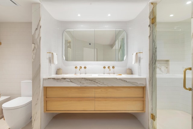 full bath featuring a stall shower, toilet, tile walls, and vanity