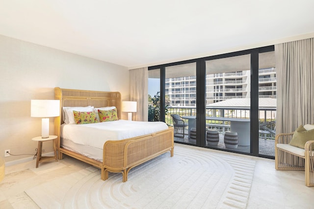 bedroom featuring expansive windows and access to exterior