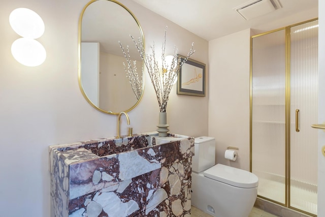 bathroom featuring toilet, visible vents, and a stall shower