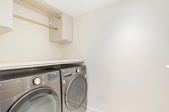 laundry room featuring washer and clothes dryer, laundry area, and baseboards