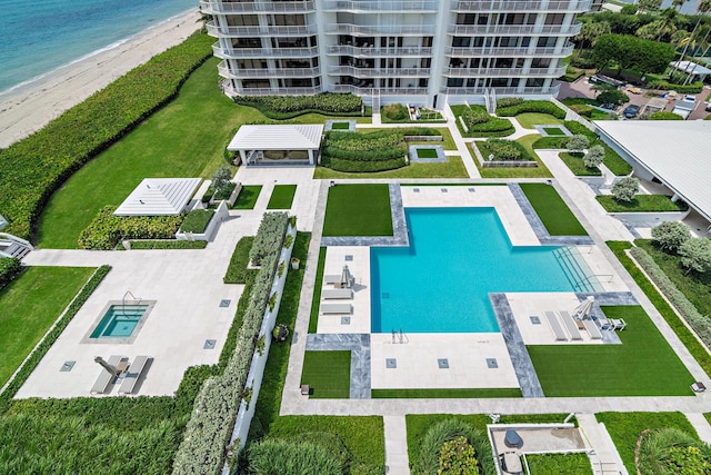 drone / aerial view with a beach view and a water view