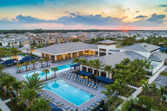 aerial view at dusk featuring a residential view