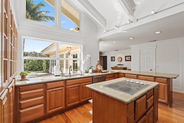 kitchen with light stone countertops, a kitchen island, a peninsula, stainless steel dishwasher, and black electric cooktop