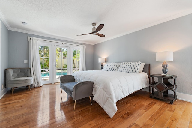 bedroom featuring access to exterior, baseboards, light wood finished floors, and ornamental molding