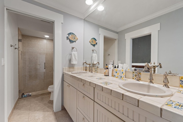 full bathroom featuring a stall shower, toilet, crown molding, and a sink