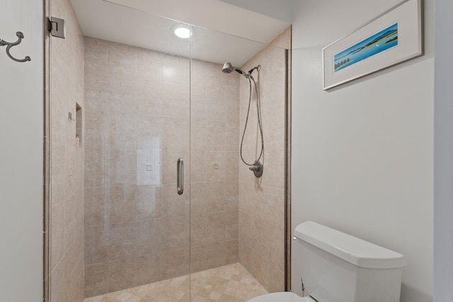 full bathroom featuring a stall shower and toilet