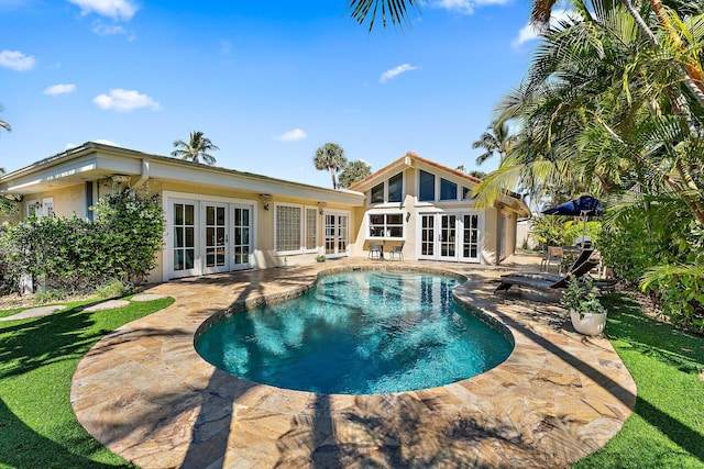 outdoor pool featuring french doors and a patio