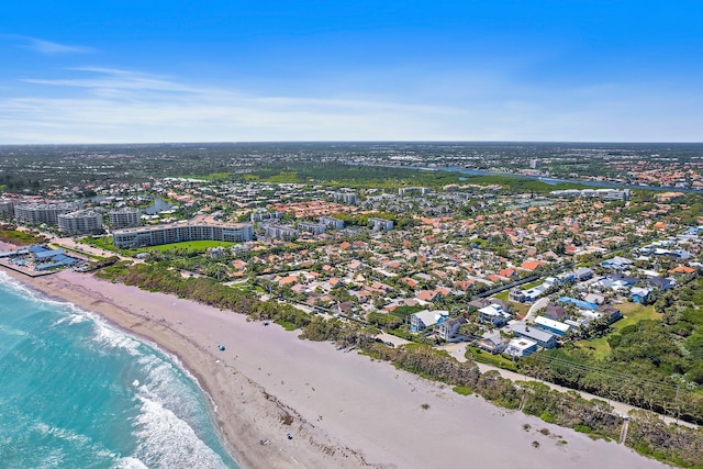 drone / aerial view featuring a city view, a beach view, and a water view