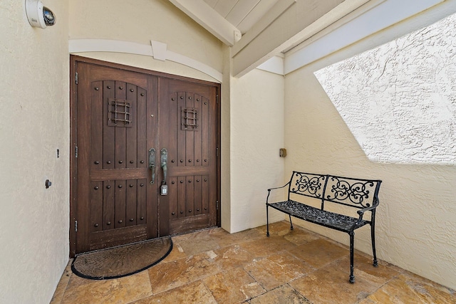 view of exterior entry with stucco siding