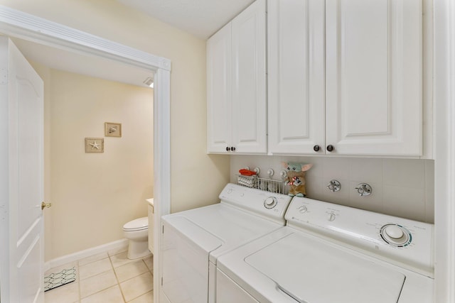 laundry room with laundry area, light tile patterned flooring, separate washer and dryer, and baseboards