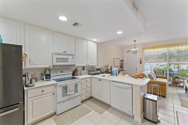 kitchen with visible vents, white cabinetry, white appliances, a peninsula, and light countertops