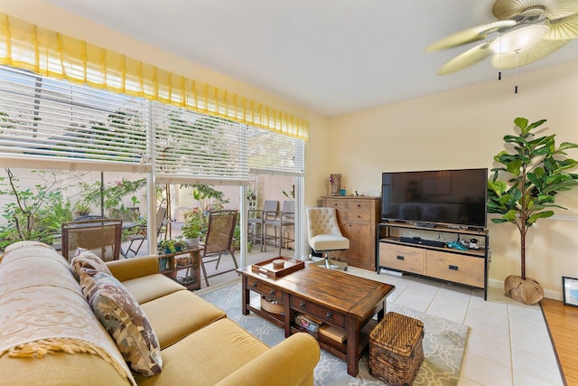 living room featuring light tile patterned floors and ceiling fan