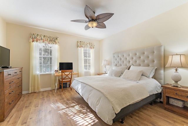 bedroom with baseboards, ceiling fan, and light wood finished floors