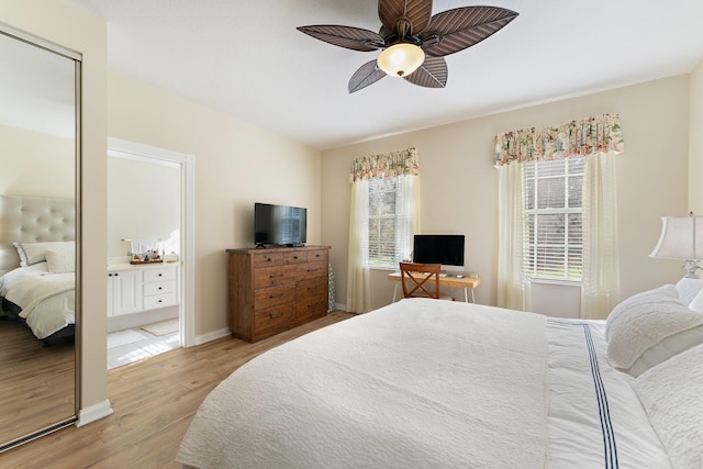 bedroom featuring baseboards, light wood-style flooring, and a ceiling fan