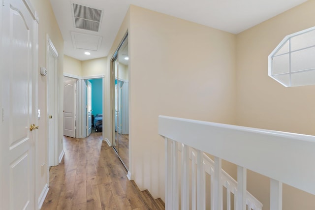 hall featuring visible vents and light wood-style flooring