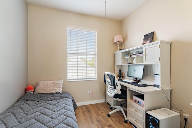 bedroom featuring light wood-style flooring and baseboards