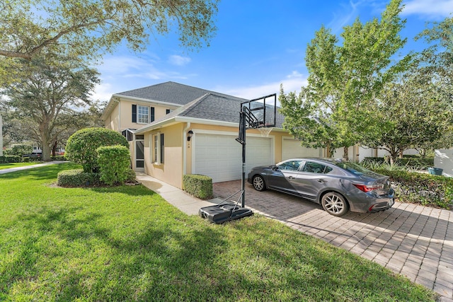 view of home's exterior with an attached garage, a shingled roof, stucco siding, a yard, and driveway