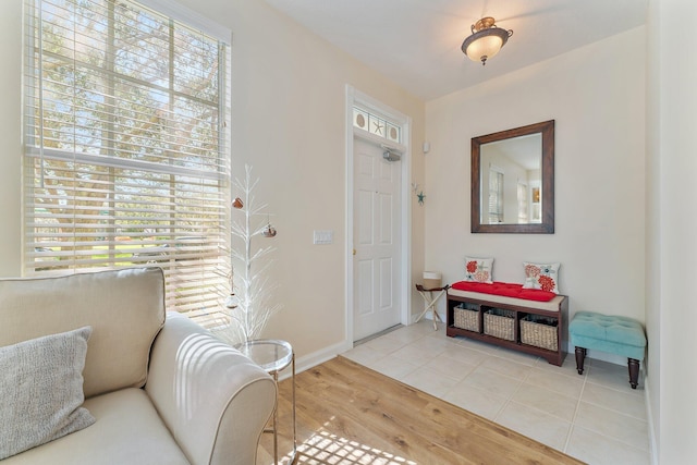 foyer entrance featuring light wood-type flooring and baseboards