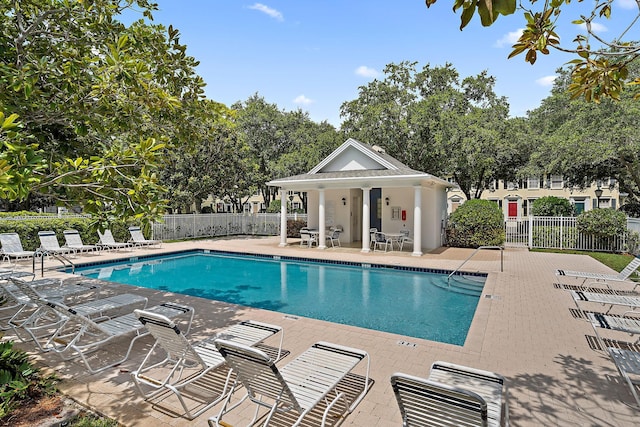 pool featuring a patio area and fence