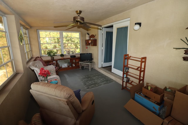 sunroom featuring a ceiling fan