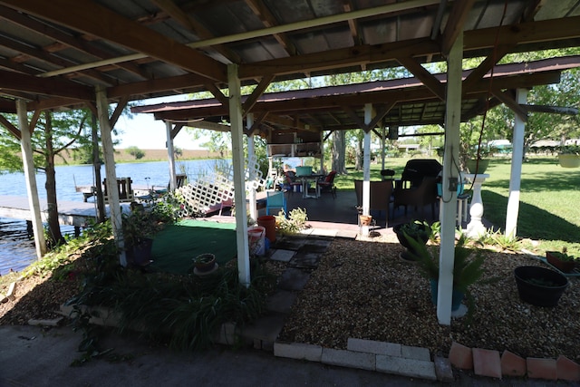 view of dock featuring a yard and a water view