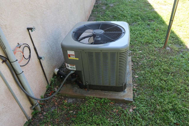 exterior details featuring central air condition unit and stucco siding