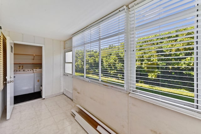 unfurnished sunroom featuring independent washer and dryer