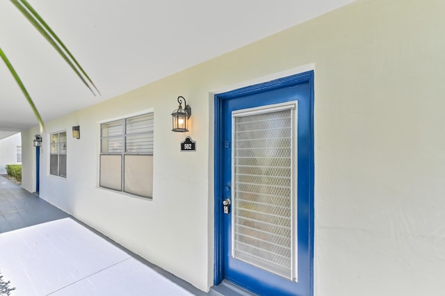 doorway to property with stucco siding